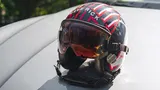 Maverick's helmet on top of Joseph Kosinski's Cayenne GTS Coupé